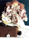 Amanda Rae.  Pattern includes 14" doll with cross-stitched heart on her petticoat.