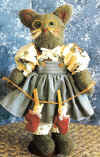 Kitty Lynell.  Pattern includes 16" mother kitten wearing glasses holding a clothesline with her 4" babies in mittens pinned on it
